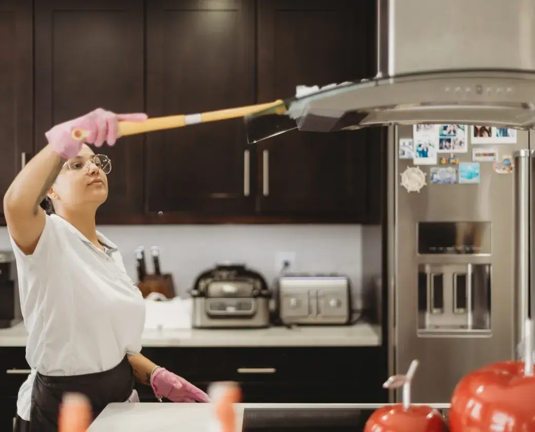 Go Cleaning Maids performing detailed deep cleaning in kitchen area