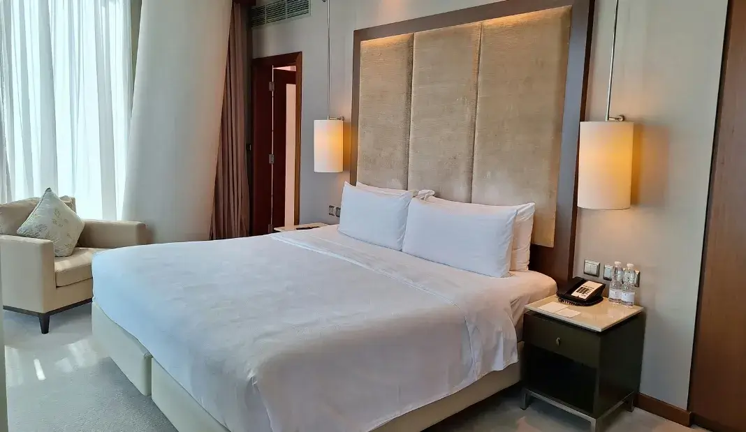 Modern clean bedroom with fresh bedding contributing to an allergen free home.