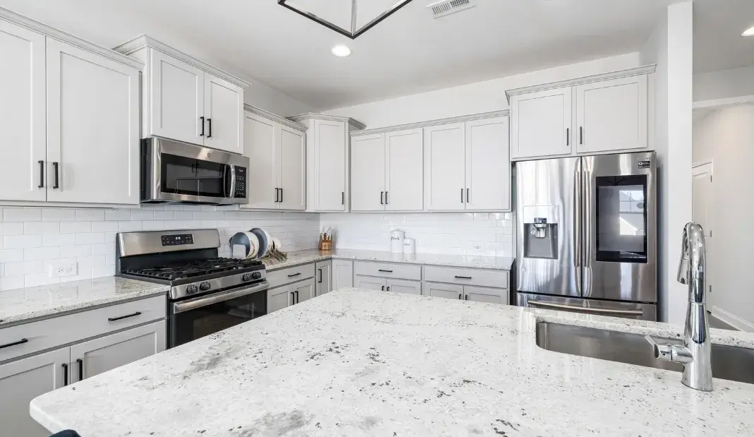 Clean and organized modern kitchen with stainless steel appliances, ideal for holiday cleaning tips.
