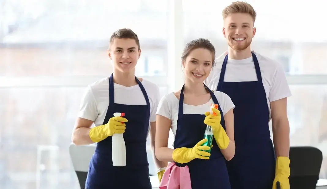 Professional cleaning team holding supplies and ready to help with holiday cleaning tips.